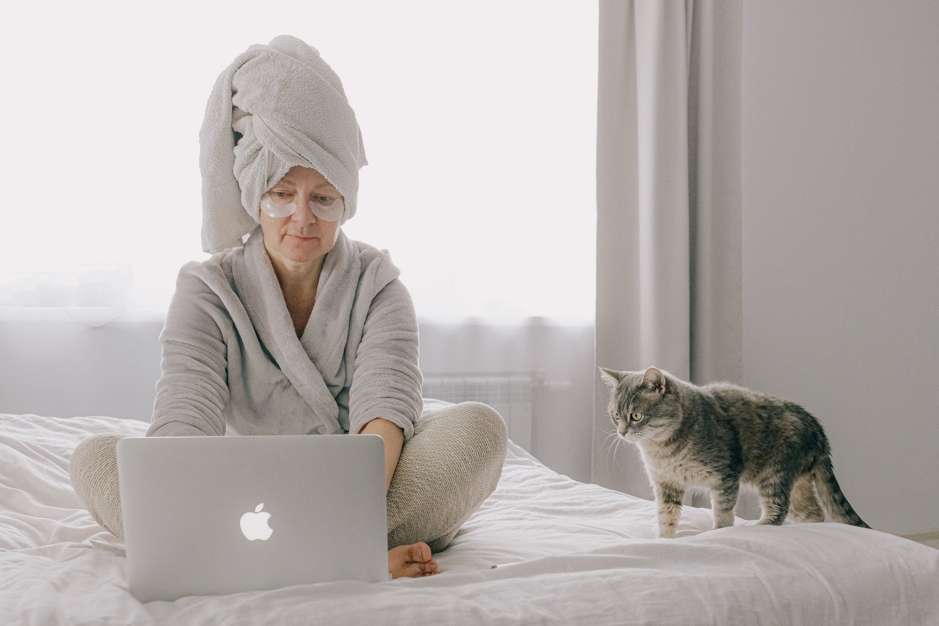 woman wearing a robe using a laptop