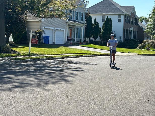 Man riding MegaWheels Electric Scooter