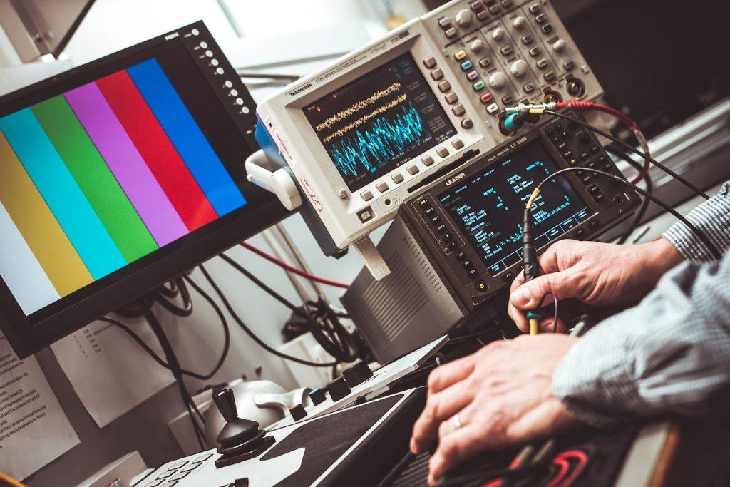 Oscilloscope and man's hands