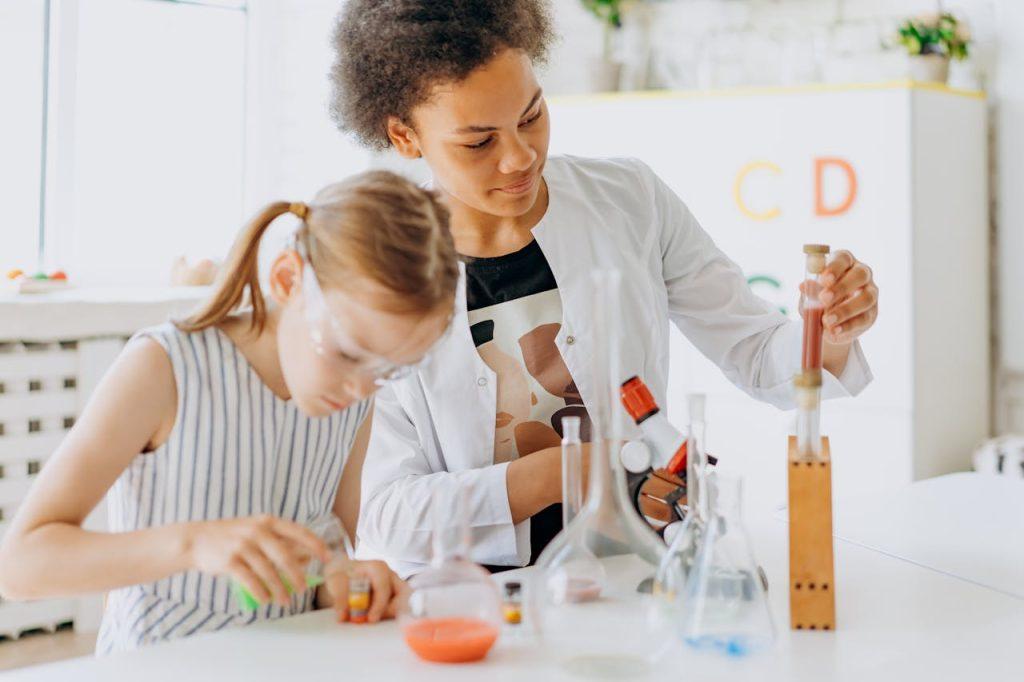A Woman and Girl Doing Experiment in the Classroom