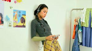 Woman using Gadhouse Miko Cassette Player and Wesley Retro Headphones.